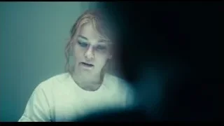 young woman looking at camera in eerie setting — Joker