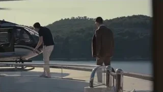 Man in suit walking to helicopter on boat — Succession