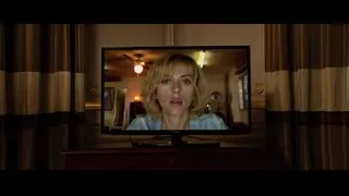 TV screen displaying shocked woman's face — Lucy