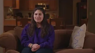 young woman on couch with serious expression — Screened Out