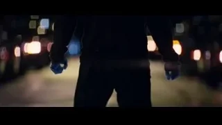 person on city street at night with hands up — The Amazing Spider Man 2