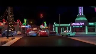 Cars characters lined up on street at night — Cars
