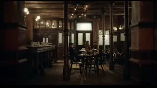 people sitting at table in dimly lit dining room — Peaky Blinders