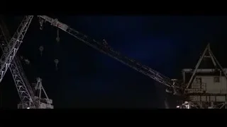 man hanging from crane at night — Spider Man 2