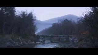 Red vehicle crossing wooden bridge over river — Cars 3