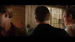 two men talking in room with window — Ford v Ferrari