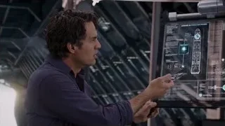 Man looking at futuristic screen holding glasses — The Avengers