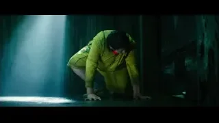 person crouching in a dark foggy room — Deadpool 2