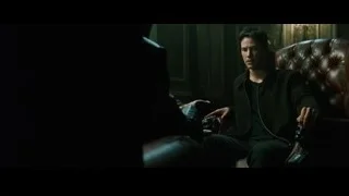 man holding gun in leather armchair — The Matrix