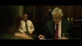 elderly man speaking at meeting table — The Social Network