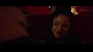 Man and woman in dim room with red walls — Creed