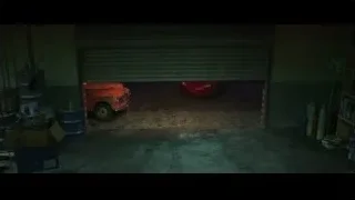 Two cars parked inside dimly lit garage — Cars 3