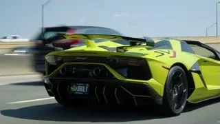 black sports car driving under bridge — Sports Cars