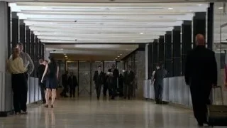 group of people walking in modern corridor — Suits