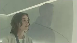 woman looking at man's reflection in mirror — Blade Runner 2049