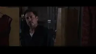man at desk with red curtains — Iron Man 3