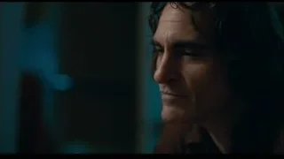 man deep in thought in dimly lit room — Joker