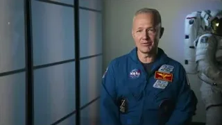 man in blue space suit by window — Elon Musk: Return to Space
