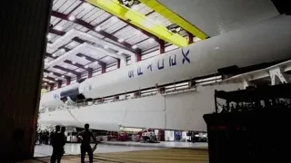 large rocket being built in hangar — Elon Musk: Return to Space