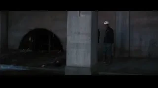 men in dark concrete tunnel — Batman: The Dark Knight Rises