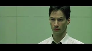Close-up of man in suit against green wall — The Matrix
