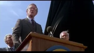 Elderly man giving speech behind podium — Rocky III