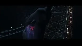 Spiderman suit standing in front of cityscape at night — The Amazing Spider Man