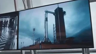screens displaying industrial construction site images — Elon Musk: Return to Space