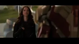Woman standing by Iron Man in futuristic setting — Iron Man 3