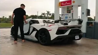 man with Lamborghini at Shell gas station — Sports Cars