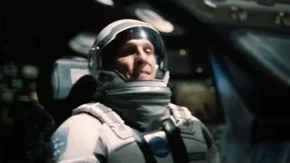 man in space suit sitting in cockpit — Interstellar