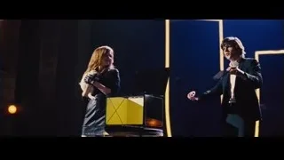 Woman singing with man on stage with piano — Now You See Me