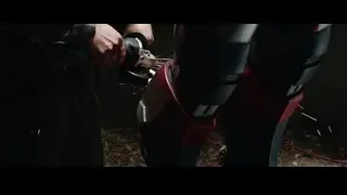 person using power tool on robot leg — Iron Man 3