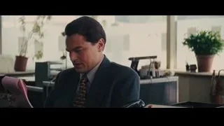man reading papers at office desk — The Wolf Of Wall Street