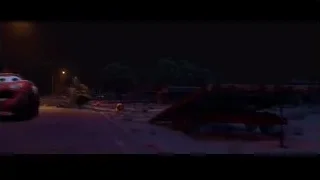 red car driving on snowy road at night — Cars