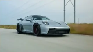 silver Porsche driving on long road — Sports Cars
