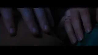 person's hands with ring on dark surface — La La Land