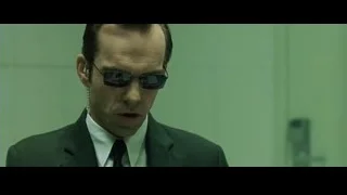 man in suit and sunglasses in green room — The Matrix