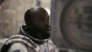 man in spacesuit in futuristic space station — Interstellar