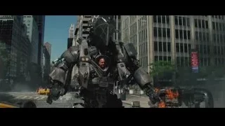 large robot standing in city street with gun — The Amazing Spider Man 2