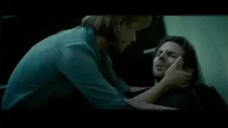 woman leaning over moaning man in dark room — Limitless