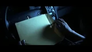 hand holding clipboard on car steering wheel — Batman: The Dark Knight