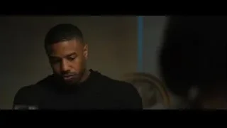 Close-up of man's face in dimly lit room — Creed 2