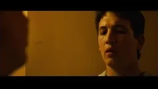 Young man's face in dimly lit room — Whiplash