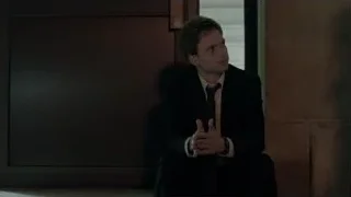 man in suit sitting in dim room — Suits