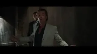Two men in suits in dim room — Iron Man 3