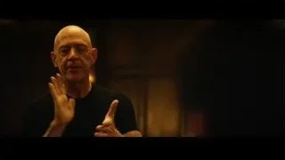 Bald man speaking in dimly lit room — Whiplash