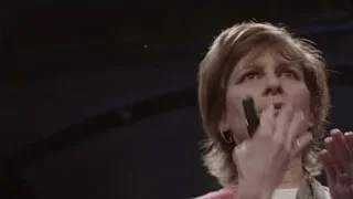 woman in pink blazer speaking on stage — Screened Out