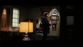 man with remote in dimly lit room — Now You See Me