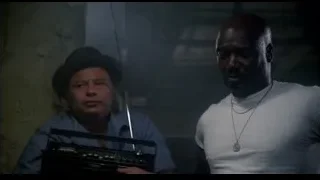 Two men with radio in dimly lit room — Rocky III